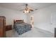 Charming bedroom with ceiling fan, built-in wooden wardrobe and a zebra patterned bedding at 30315 Lettingwell Cir, Wesley Chapel, FL 33543