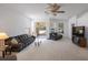 Living room features comfortable seating, large TV, and sliding doors to patio at 30315 Lettingwell Cir, Wesley Chapel, FL 33543