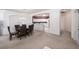 Dining room with glass top table and dark chairs, open to kitchen and living room at 30315 Lettingwell Cir, Wesley Chapel, FL 33543