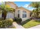 Front entrance of a single story house featuring a double door and lush landscaping at 30315 Lettingwell Cir, Wesley Chapel, FL 33543