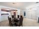 Dining room with glass-top table and chairs, adjacent to kitchen at 30315 Lettingwell Cir, Wesley Chapel, FL 33543