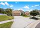 Tan duplex with two-car garages at 30315 Lettingwell Cir, Wesley Chapel, FL 33543