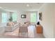 Spacious living room with light gray sofa and two armchairs at 17476 Quentin Ave, Port Charlotte, FL 33954