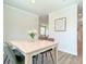 Bright dining room with light wood table and four green chairs at 17476 Quentin Ave, Port Charlotte, FL 33954