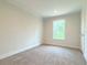 Simple bedroom with carpet flooring and a window at 17476 Quentin Ave, Port Charlotte, FL 33954