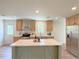 Modern kitchen with light wood cabinets, a large island, and stainless steel appliances at 17476 Quentin Ave, Port Charlotte, FL 33954