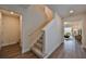 Elegant staircase leading to the second floor with hardwood floors at 9018 Rally Spring Loop, Wesley Chapel, FL 33545