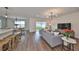 Open concept living area with hardwood floors and backyard access at 9018 Rally Spring Loop, Wesley Chapel, FL 33545