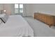 Spacious main bedroom with large bed, dresser, and window views at 9018 Rally Spring Loop, Wesley Chapel, FL 33545
