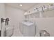 Bright laundry room with washer, dryer, and ample storage shelving at 9018 Rally Spring Loop, Wesley Chapel, FL 33545