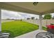 Covered patio with grassy backyard and privacy fence at 9018 Rally Spring Loop, Wesley Chapel, FL 33545