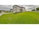 Two-story house with attached garage and grassy lawn at 9018 Rally Spring Loop, Wesley Chapel, FL 33545