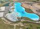 Aerial view of a large, crystal-clear lagoon with beach at 9018 Rally Spring Loop, Wesley Chapel, FL 33545