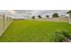 Large backyard with a vinyl fence and a grassy area at 9018 Rally Spring Loop, Wesley Chapel, FL 33545
