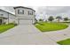 Two-story house with attached garage and landscaped yard at 9018 Rally Spring Loop, Wesley Chapel, FL 33545