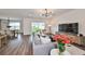 Spacious living area with hardwood floors, backyard access, and ample natural light at 9018 Rally Spring Loop, Wesley Chapel, FL 33545