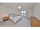 Bright and airy main bedroom with plush bed, wood nightstands, and neutral decor at 9018 Rally Spring Loop, Wesley Chapel, FL 33545