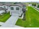 Two-story house with a two-car garage and a manicured lawn at 9018 Rally Spring Loop, Wesley Chapel, FL 33545