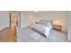 Main bedroom with King bed, nightstands, and a dresser with neutral color palette at 9018 Rally Spring Loop, Wesley Chapel, FL 33545