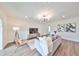Living room with gray sofa, wood accent wall, and hardwood floors at 9018 Rally Spring Loop, Wesley Chapel, FL 33545