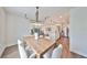 Dining room with wood table, chandelier and kitchen views at 9018 Rally Spring Loop, Wesley Chapel, FL 33545