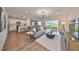 Open concept living room and kitchen with hardwood floors at 9018 Rally Spring Loop, Wesley Chapel, FL 33545