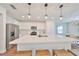 Modern kitchen with white cabinetry, large island, and stainless steel appliances at 9018 Rally Spring Loop, Wesley Chapel, FL 33545