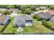Aerial view showcases the home's backyard with patio, fire pit, and its proximity to neighboring houses and lush landscaping at 28330 Openfield Loop, Wesley Chapel, FL 33543