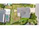 Aerial view of backyard featuring a fire pit, and adjacent yard with enclosed pool and playground at 28330 Openfield Loop, Wesley Chapel, FL 33543