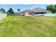 Expansive back yard with lush green lawn, patio area, and mature trees, perfect for outdoor enjoyment at 28330 Openfield Loop, Wesley Chapel, FL 33543