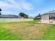 Spacious back yard featuring a well-maintained lawn, privacy fence, and a patio area with comfortable seating at 28330 Openfield Loop, Wesley Chapel, FL 33543