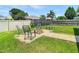 Green backyard featuring a stone fire pit and seating, creating an inviting outdoor gathering space at 28330 Openfield Loop, Wesley Chapel, FL 33543