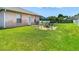 Wide view of a landscaped backyard with a firepit and outdoor seating, great for entertaining at 28330 Openfield Loop, Wesley Chapel, FL 33543