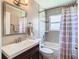 Bathroom with tiled shower over tub, large vanity with sink, and modern fixtures at 28330 Openfield Loop, Wesley Chapel, FL 33543
