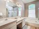 Well-lit bathroom with double sinks, soaking tub, and a separate shower stall at 28330 Openfield Loop, Wesley Chapel, FL 33543