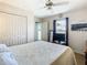 Bright bedroom with ceiling fan, closet doors, and view to backyard at 28330 Openfield Loop, Wesley Chapel, FL 33543