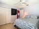 Bright bedroom with wood floor, ceiling fan and ensuite bathroom at 28330 Openfield Loop, Wesley Chapel, FL 33543