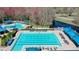 Resort-style community pool offers multiple swim areas, lounge chairs, and lush landscaping for residents at 28330 Openfield Loop, Wesley Chapel, FL 33543
