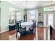 Elegant dining room with hardwood floors, large windows, and a mirrored wall at 28330 Openfield Loop, Wesley Chapel, FL 33543