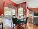 Dining room with view to the screened patio, the adjacent living room, and the kitchen's breakfast bar at 28330 Openfield Loop, Wesley Chapel, FL 33543