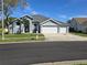 Charming single-story home with a well-manicured lawn, showcasing great curb appeal at 28330 Openfield Loop, Wesley Chapel, FL 33543