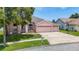 Attractive single-story home with a three-car garage and a neat front lawn on a sunny day at 28330 Openfield Loop, Wesley Chapel, FL 33543