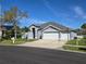 Well-manicured two-story home featuring a three-car garage and a spacious driveway at 28330 Openfield Loop, Wesley Chapel, FL 33543