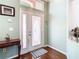 Inviting foyer featuring a decorative front door with sidelights and gleaming hardwood floors at 28330 Openfield Loop, Wesley Chapel, FL 33543