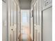 Hallway leading to bathroom with view of soaking tub and natural light at 28330 Openfield Loop, Wesley Chapel, FL 33543