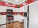 Kitchen features stainless steel appliances and a built-in desk, offering both functionality and style at 28330 Openfield Loop, Wesley Chapel, FL 33543