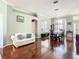 Open concept living and dining area with hardwood floors, neutral paint, and plenty of light at 28330 Openfield Loop, Wesley Chapel, FL 33543