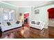 Cozy living room featuring hardwood floors, neutral paint, and ample seating for relaxation at 28330 Openfield Loop, Wesley Chapel, FL 33543