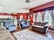Living room with access to kitchen and dining areas, features comfortable seating and ample natural light at 28330 Openfield Loop, Wesley Chapel, FL 33543