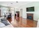 Bright, open-concept living space with dining area, hardwood floors, and fireplace at 28330 Openfield Loop, Wesley Chapel, FL 33543